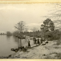 Ladies on shoreline, Neuse River [?], possible earthworks in background